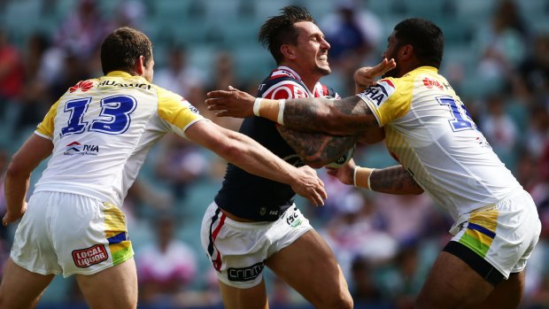 Leading by example: Mitchell Pearce takes on the line against the Raiders.