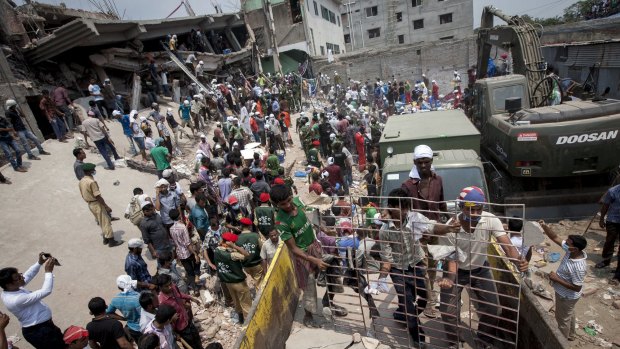 Rescue workers and volunteers search by hand for victims amongst the debris of the collapsed Rana Plaza building in Dhaka, Bangladesh, on Friday, April 26, 2013. 