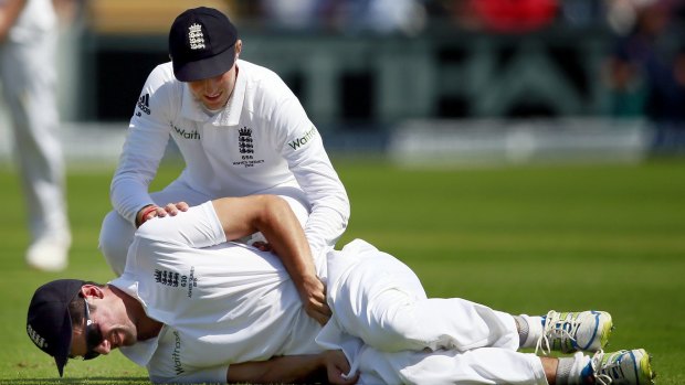 England captain Alastair Cook is consoled by vice-captain Joe Root after being struck in the groin by the ball.