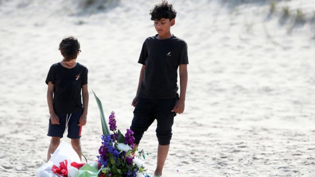 Nadeen Hammad, 7, and his brother Ahmad Hammad, 10, at the vigil. Shaun Oliver was trying to reach Ahmad and others when he drowned.