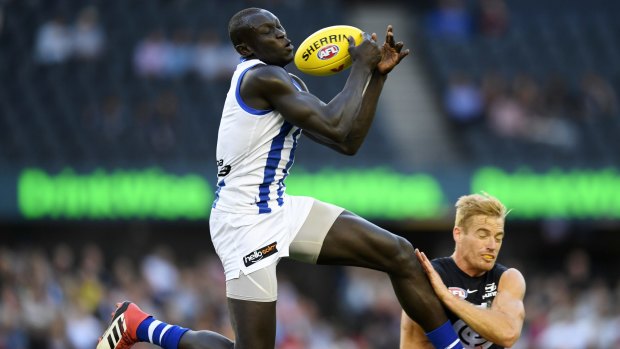 Majak Daw flies for North Melbourne.
