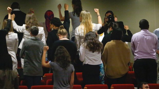 UN staff turn their backs in a silent protest against the appointment of Wonder Woman as ambassador for women and girls.
