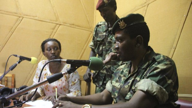 Major General Godefroid Niyombare flanked by former defence minister Cyrille Ndayirukiye (standing) inside the Radio Publique Africaine broadcasting studios in Burundi's capital Bujumbura earlier this month.