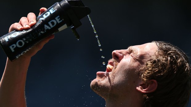 Beating the heat: Geelong's Billie Smedts takes a drink after a run during pre-season training in December last year.