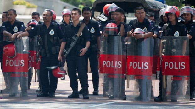 Malaysian police take position outside the federal court ahead of the ruling.