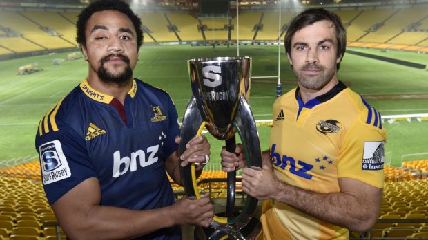 Highlanders captain Nasi Manu and his Hurricanes counterpart Conrad Smith pose with the Super 15 trophy in Wellington on Friday.