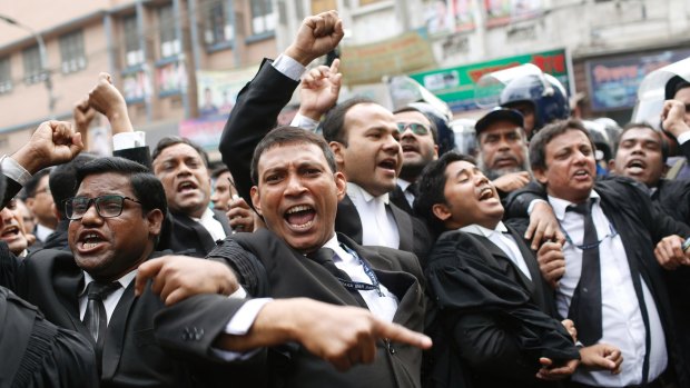 Supporters of the Bangladesh Nationalist Party shout slogans outside the court in Dhaka.