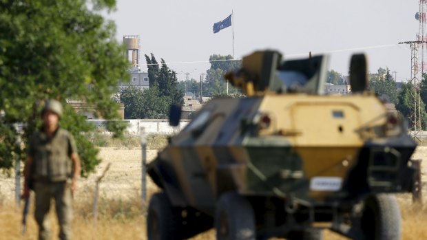 An Islamic State flag flies in the northern Syrian town of Tel Abyad in June, seen from the Turkish border town of Akcakale.