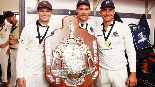 Peter Handscomb, Scott Boland and Marcus Stoinis of the Bushrangers with the Sheffield Shield after beating South Australia.