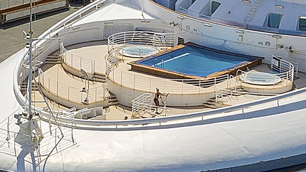 A woman exercises on the bow of the Grand Princess shortly after it docked in Oakland, California.