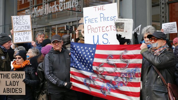 Demonstrators show  solidarity with the press in front of The New York Times building in  February.  