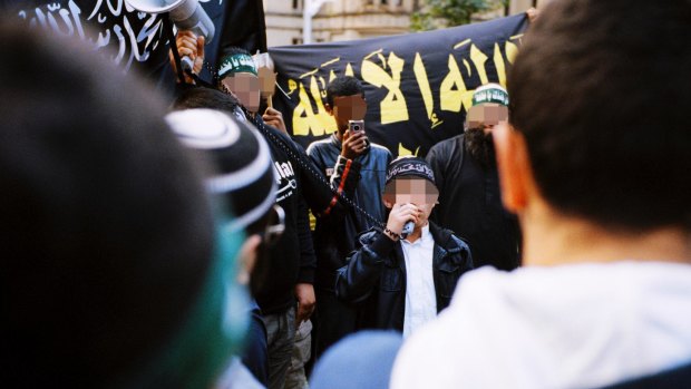 The 16-year-old boy arrested on Wednesday is pictured in 2012, then aged 12, speaking through a megaphone to rioters in Hyde Park.