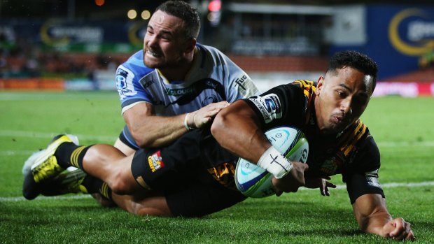 In he goes: Toni Pulu of the Chiefs dives over to score a try.