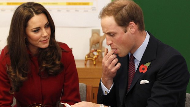 Checking for any signs ... the Duchess of Cambridge looks on as Prince William tastes an energy bar at a UNICEF event in 2011.