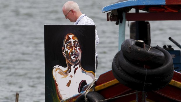 Lawyer Julian McMahon carries Myuran Sukumaran's self portrait of his upper body, with a black hole over his heart. 