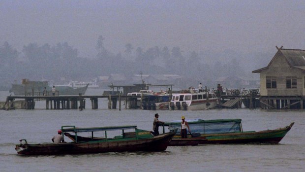 Boats sail by in the port of Tanjung Pinang island.