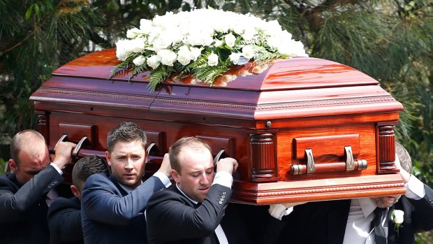 Australian cricket captain Michael Clarke helps carry the coffin of Phillip Hughes.