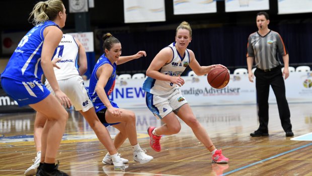 Capital moves: Canberra’s Alice Coddington drives against Bendigo’s Sara Blicavs (far left) and Tessa Lavey.