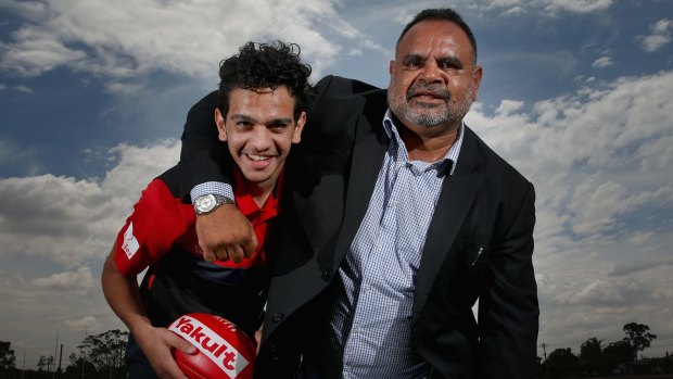 Michael Long, pictured with his son, Jake, might have been a great footballer, but he is an Aboriginal man first and foremost.