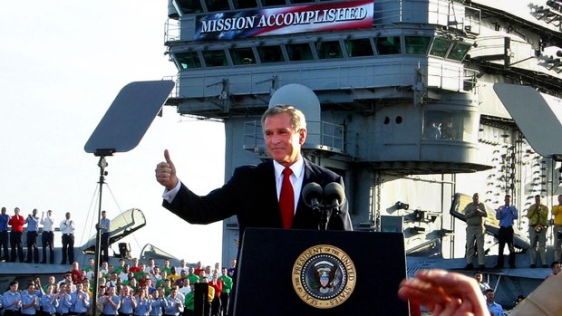 Then-President Bush flashes a "thumbs-up" aboard the aircraft carrier USS Abraham Lincoln off the California coast in 2003 after declaring the end of major combat in Iraq.