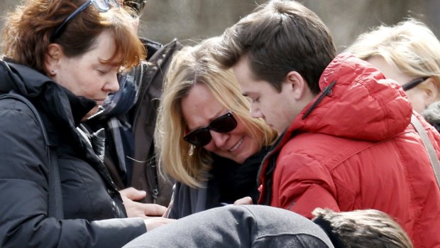 People identified by the mayor of Le Vernet as family members of the pilot of the Germanwings Airbus A320 react as they pay their respects at the memorial for the victims of the air disaster in the village of Le Vernet.