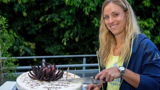 Germany's Angelique Kerber cuts a birthday cake to celebrate her 30th birthday at the Australian Open.