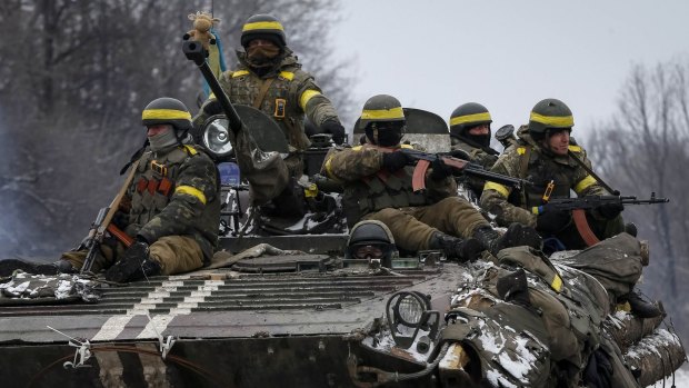 Members of the Ukrainian armed forces ride on an armoured personnel carrier near Debaltseve, eastern Ukraine, on Tuesday.