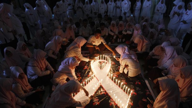 Indonesian medical students light candles during a vigil commemorating World AIDS day last year. 