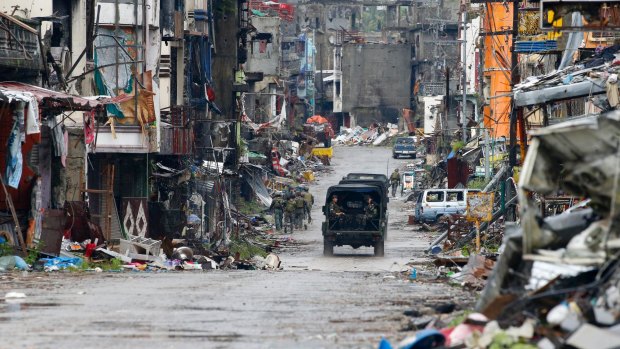 Philippine troops drive through Marawi last month after the city was declared liberated following a months-long siege and battle against Islamist militants.
