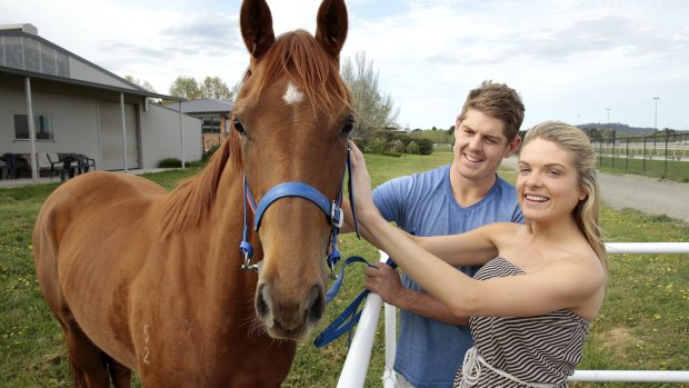 Erin Molan and Daniel Hughes with their horse Snippet Of Hope at Nick Olive's stables at Thoroughbred Park..