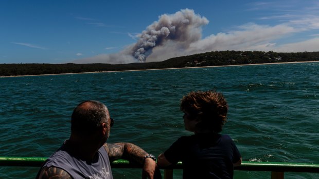A bushfire burning in the Royal National Park is seen from the Cronulla-to-Bundeena Ferry.