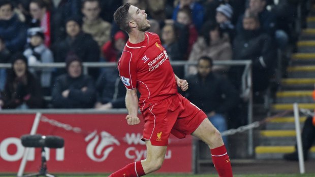 Liverpool’s Jordan Henderson celebrates scoring against Swansea. 
