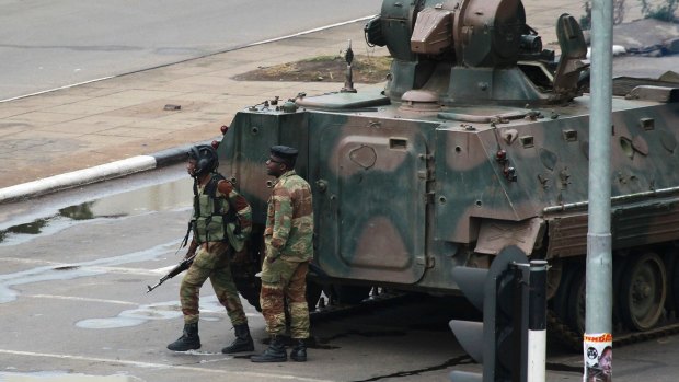 A military tank is seen with armed soldiers on the road leading to President Robert Mugabe's office in Harare, Zimbabwe.