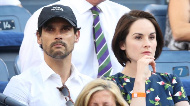 John Dineen and Michelle Dockery watch the women's singles semifinal match at the 2013 US Open. Dineen passed away on Sunday, reportedly following a battle with a rare form of cancer.