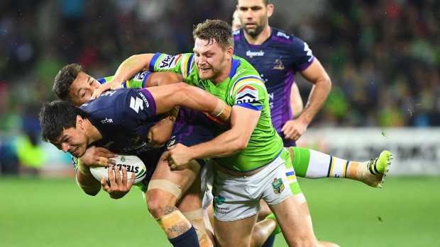 Jordan McLean of the Storm is tackled during the preliminary final between the Melbourne Storm and the Canberra Raiders at AAMI Park on Saturday.