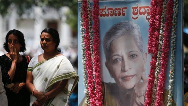 Mourners next to a portrait of Gauri Lankesh during the public viewing of her body in Bangalore on Wednesday.