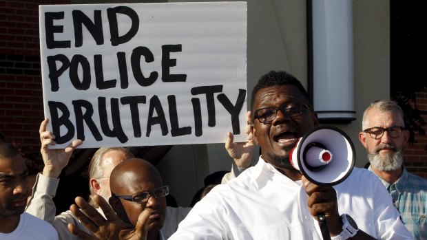 Pastor Derrick Golden speaks during a protest against what demonstrators call police brutality after a pool party in McKinney, Texas.