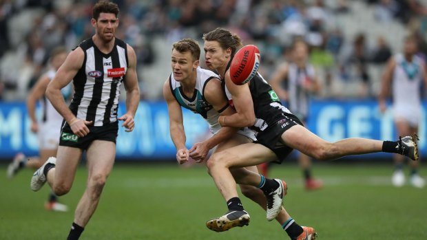 Port's Robbie Gray is tackled by Magpie Tom Langdon, but proved a handful all day.