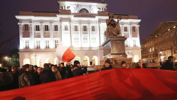 Students protest in front of the Copernicus monument in Warsaw, Poland.