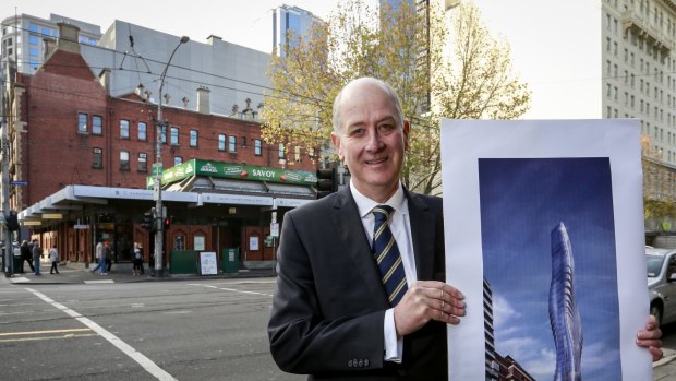 Planning Minister Richard Wynne at the Savoy Tavern site, with a picture of the 68-floor tower. 