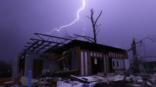 Lightning illuminates a house after a tornado touched down in Jefferson County, Alabama, damaging several houses, on Christmas day.