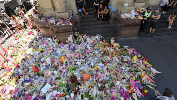 The public lay flowers at Bourke Street after five people died.