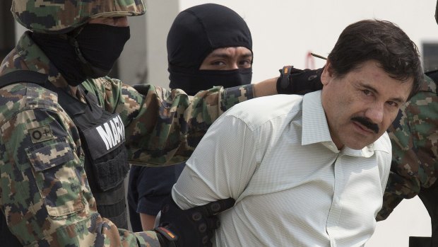 The drug trafficker Joaquin Guzman Loera is guarded by members of Mexico's navy following his arrest on Saturday.