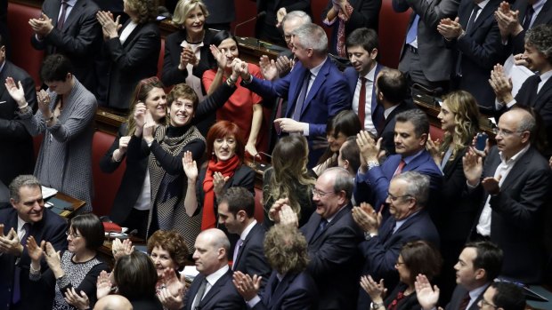 Italian legislators applaud the election of Italy's new President Sergio Mattarella.