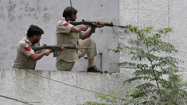 Indian policemen take up position next to the police station in Dinanagar.