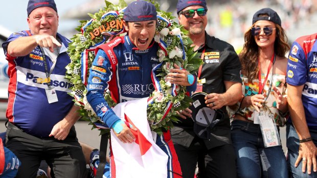 Japanese driver Takuma Sato celebrates his victory in the 101st Indy 500.