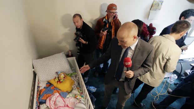 Members of the media crowd into a child's room in an apartment in Redlands, California, shared by San Bernardino terrorists Syed Farook and his wife, Tashfeen Malik.