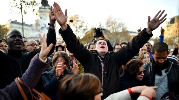 Members of the public pay tribute to the victims at the Place de la Republique.