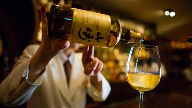 A bartender pours Yamazaki whisky at the Hibiya whisky bar in the Ginza district in Tokyo.