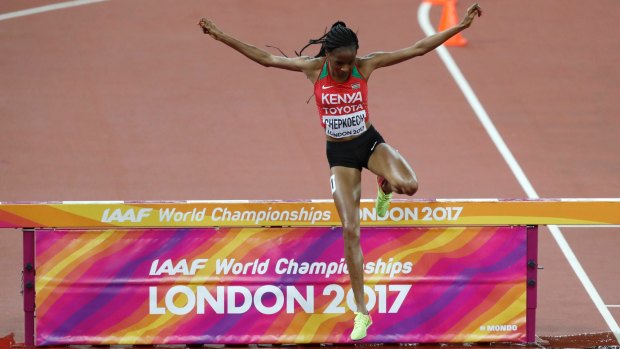 Kenya's Beatrice Chepkoech crosses the water jump in the women's 3000m steeplechase final, after initially sailing past it.